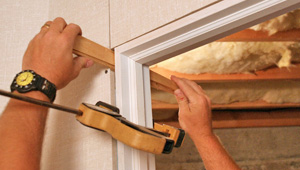 Installing trim and finishing touches to a remodeled basement in Gibsonia, PA