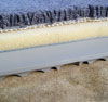 Sub-floor tiles are unfinished so that you can install wall-to-wall carpeting on top of it